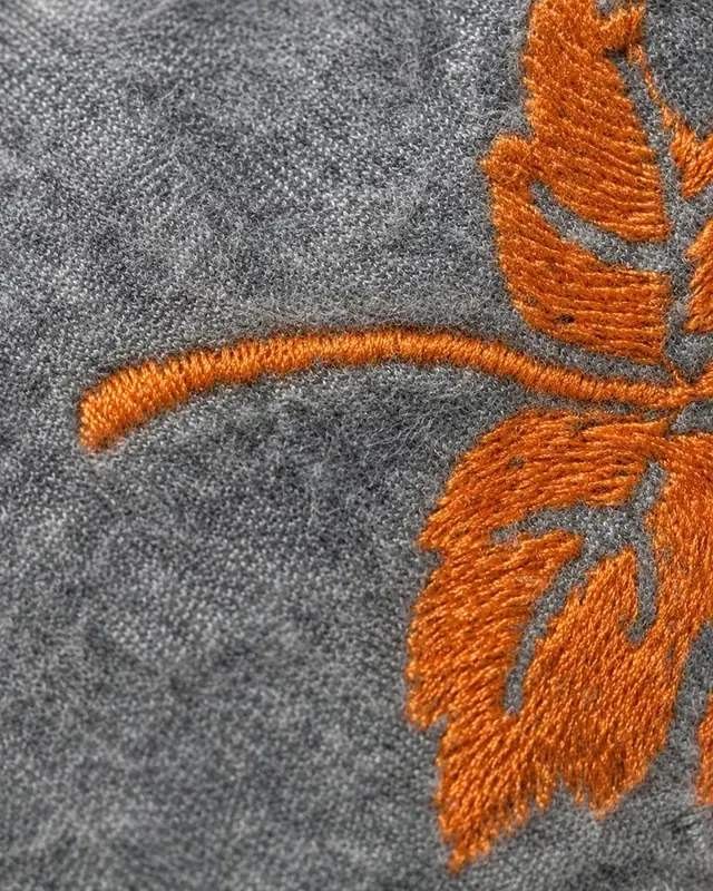 Embroidered finish on a garment